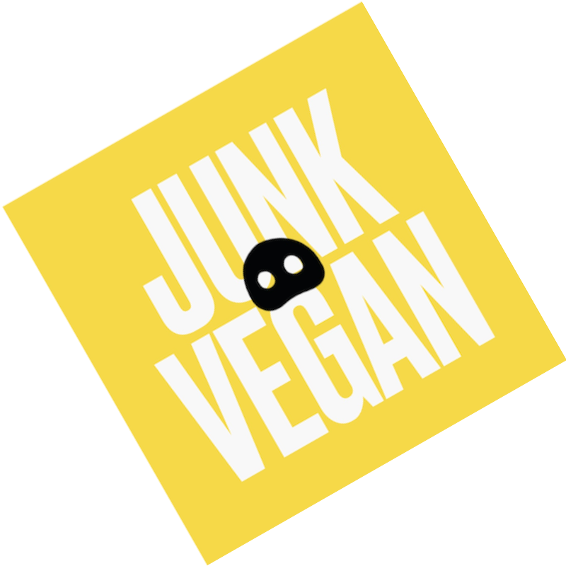 Yellow square with white bold text reading 'Junk Vegan' and a small black skull icon in the center.