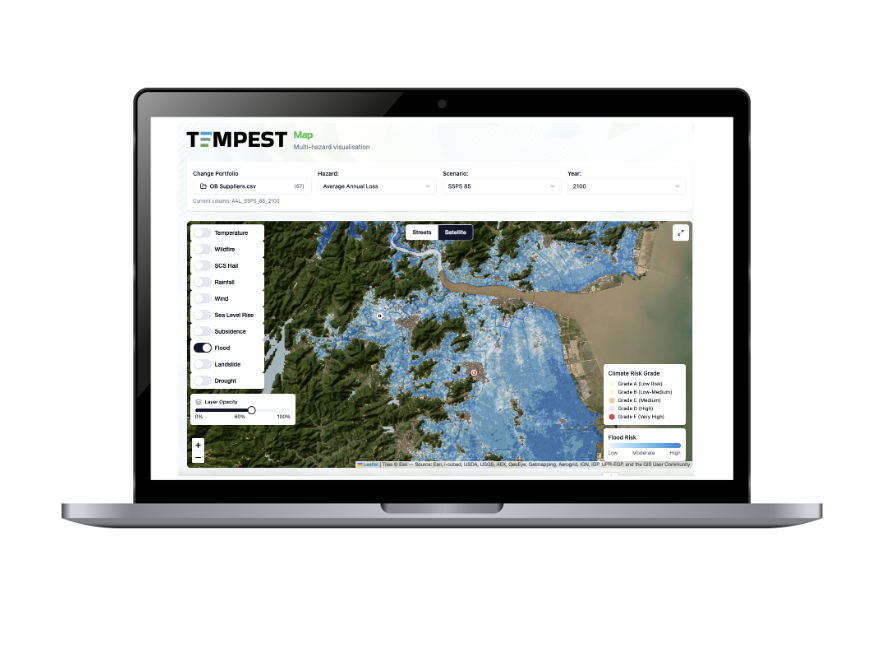 Laptop displaying a multi-hazard visualization map titled 'TEMPEST Map' showing flood risk levels with blue shading in a mountainous area, along with a legend indicating flood risk and climate risk grades.