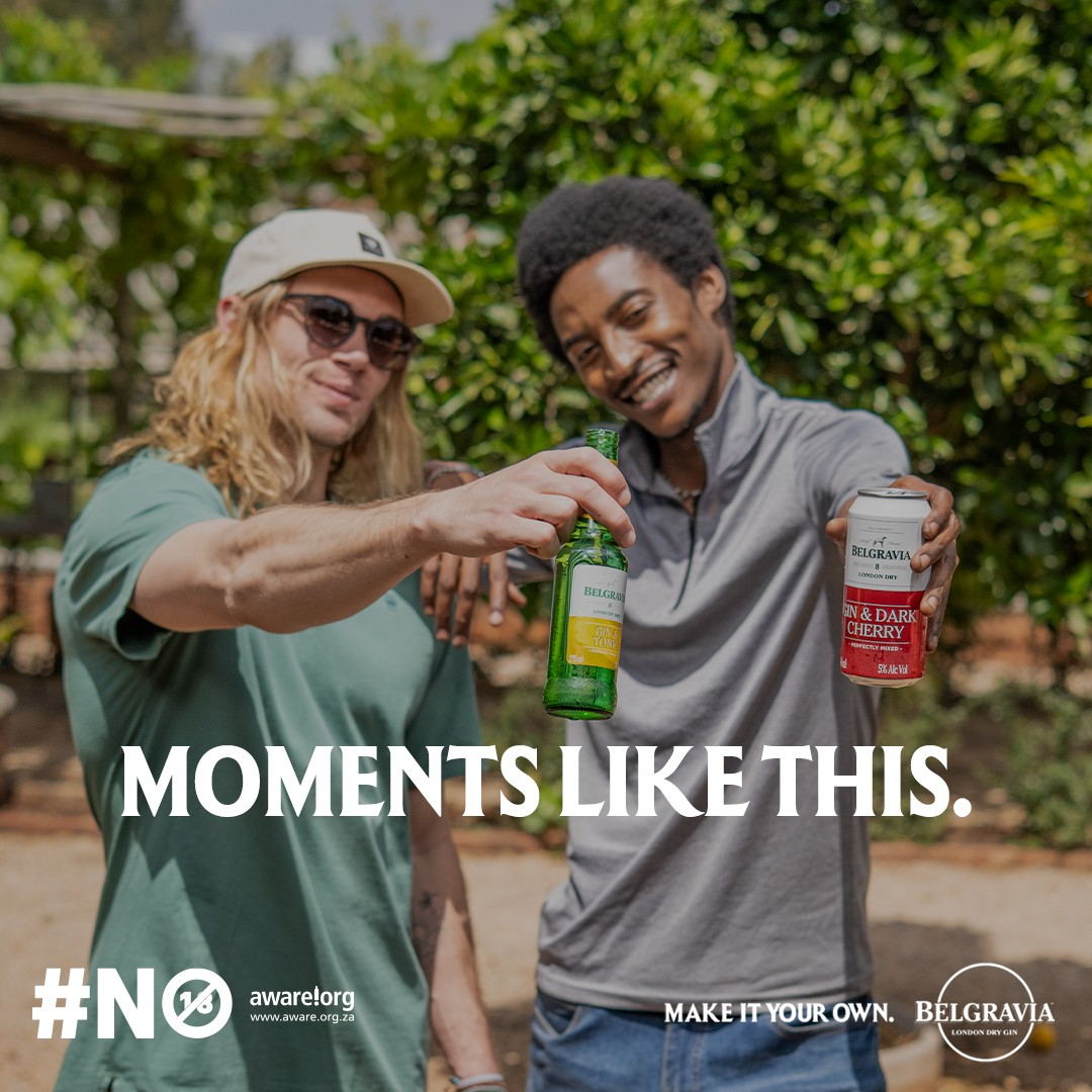 KUNDAI Madhandara and NEIL Marais from AURA Models celebrating outdoors with drinks, smiling and clinking bottles, with greenery in the background.