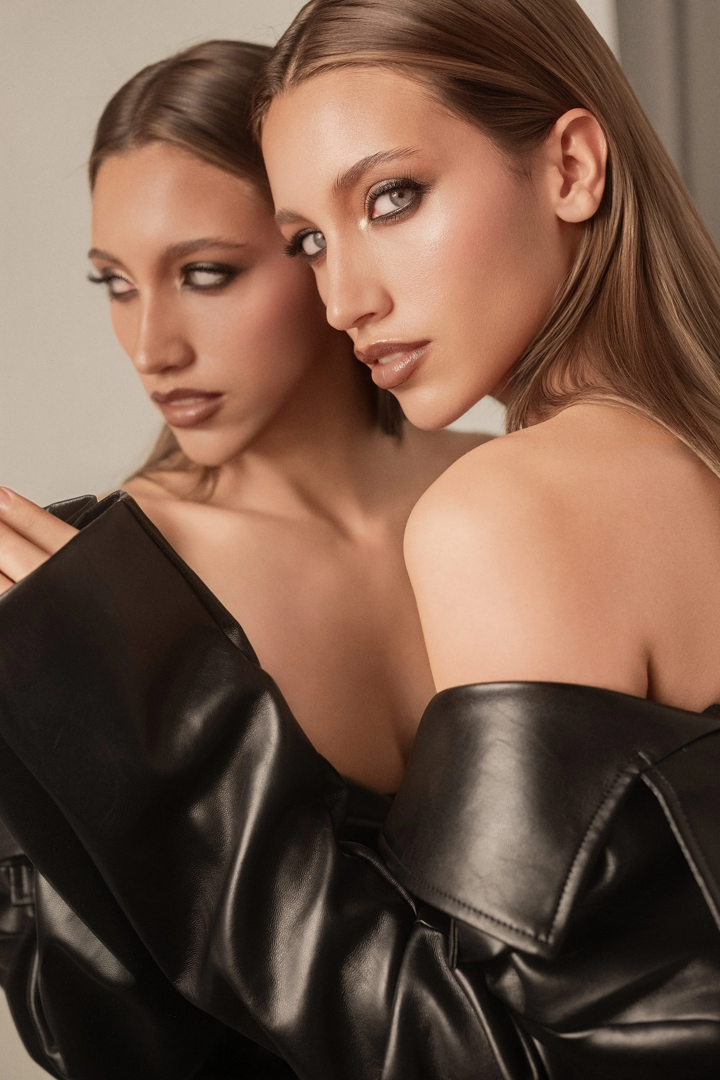 MEGAN Leigh from AURA Models with blonde hair and smoky eye makeup, wearing black leather jacket, looking intensely at the camera.
