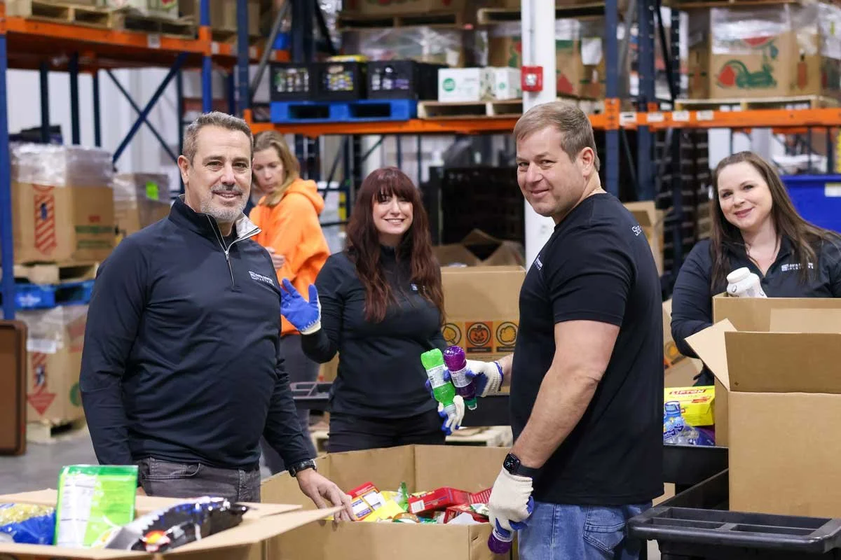 The Pennsylvania Data Center Partners team packing boxes of shelf-stable goods to be handed out to food pantries in Central Pennsylvania.