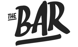 Silhouette of a man and woman sitting on a bench in a park.