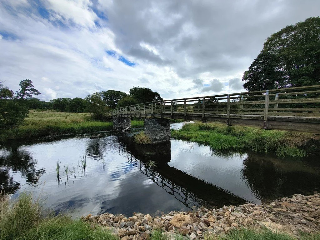Over the footbridge.