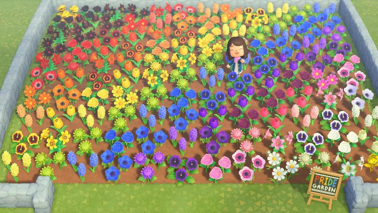 Colorful flower garden with various blooming flowers organized in rainbow order, a smiling female figure standing among the flowers, and a sign reading "PRIDE GARDEN".