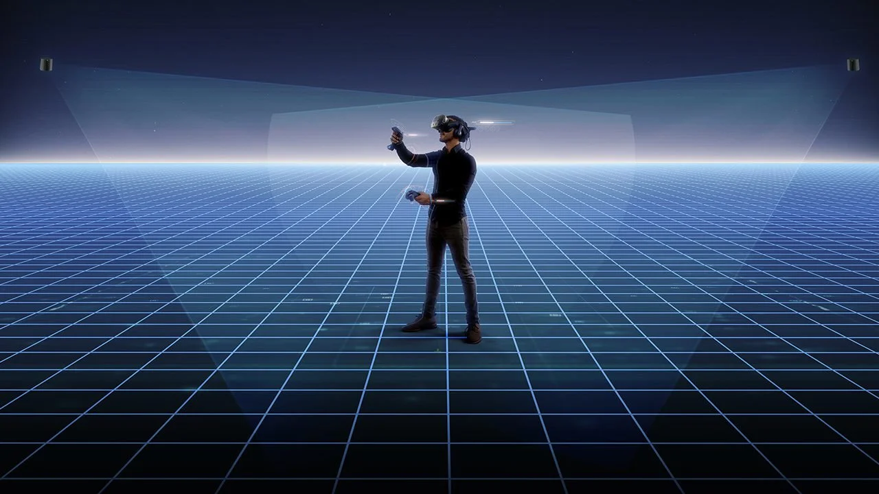 Person wearing a virtual reality headset and gloves, standing on a grid-like digital landscape, with fog and stars in the background.