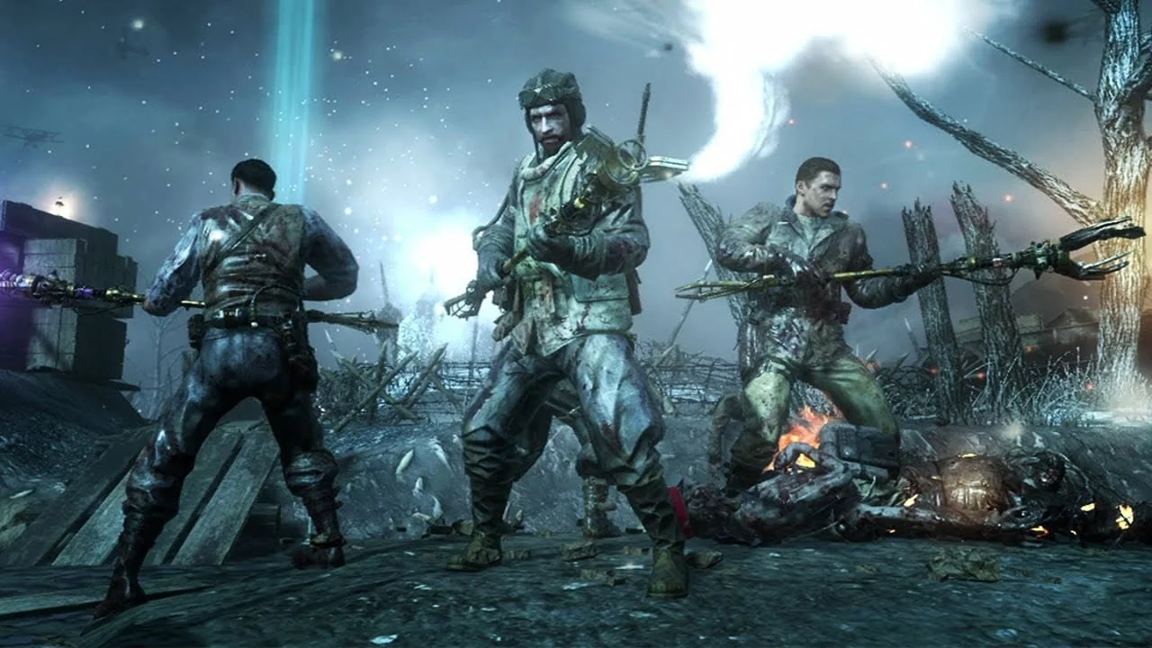 Three soldiers armed with futuristic weapons standing amidst a war-torn landscape with smoke, fire, and damaged structures.