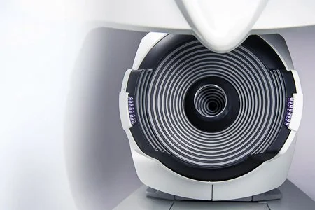 Close-up of a medical imaging machine, likely an MRI or CT scanner, with a large circular opening.