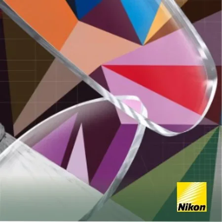 Close-up of a color calibration tool with a Nikon logo, showing various color patches and a clear glass edge.