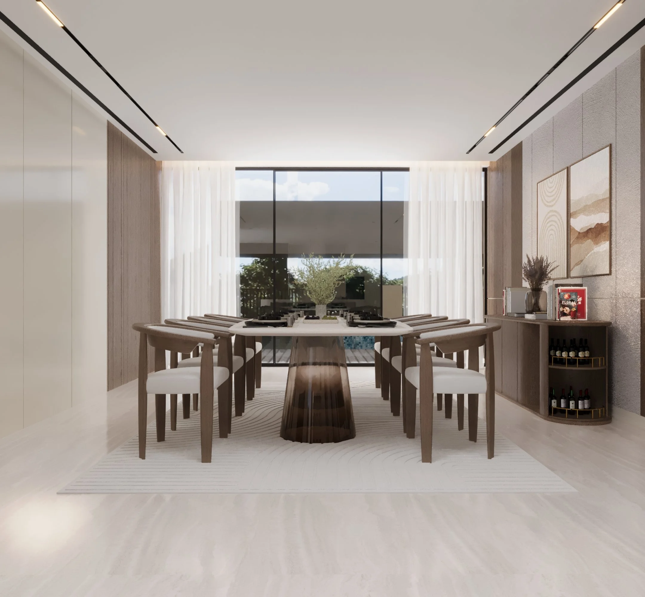 Modern dining room with a long white table, twelve chairs, and large glass doors leading outside. The room has light-colored flooring, a textured wall with artwork, and a sideboard with decorative items and wine bottles.