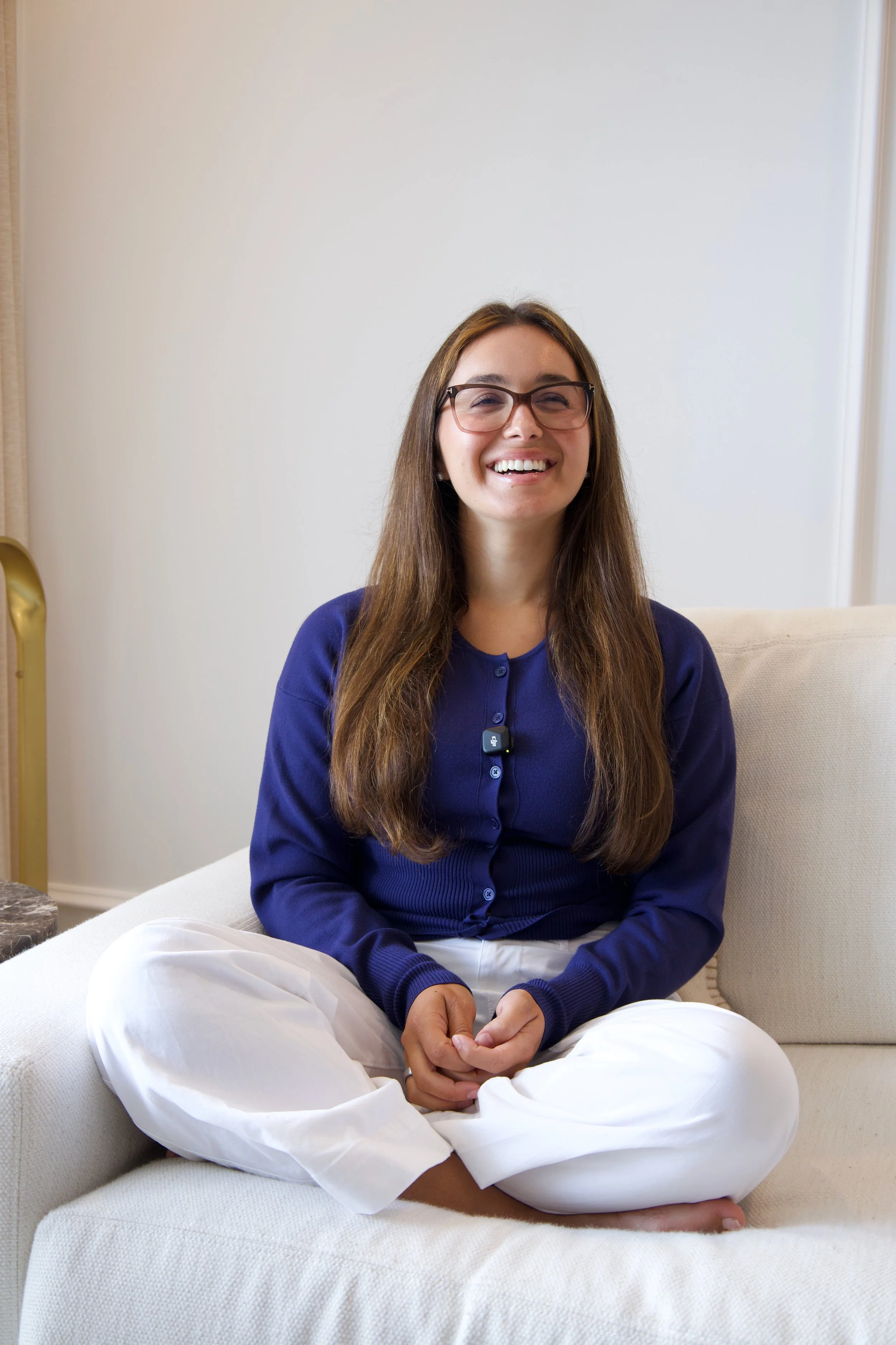 Dr. Sonya Arrigo, naturopathic doctor, sitting cross-legged and smiling