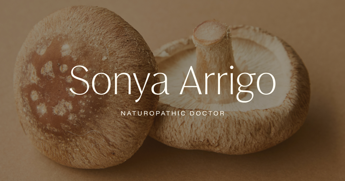 Close-up of two shiitake mushrooms, one with a cap showing white spots, on a beige background, with text overlay: Sonya Arrigo, Naturopathic Doctor.