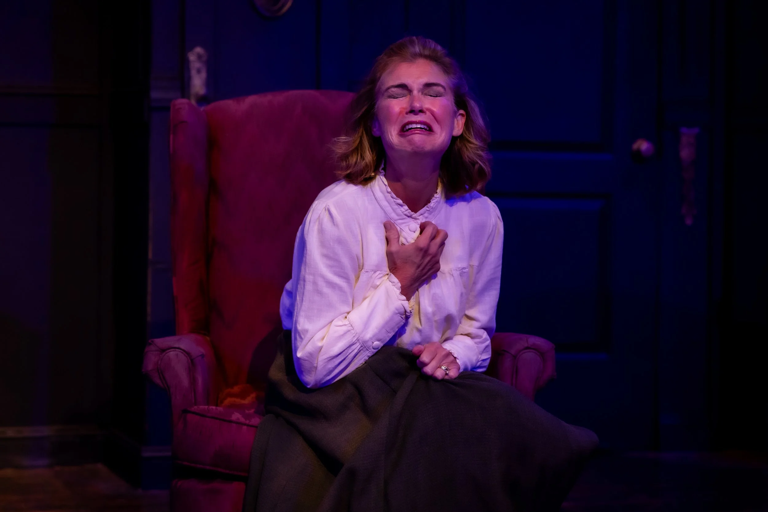 a woman crying helplessly in a chair