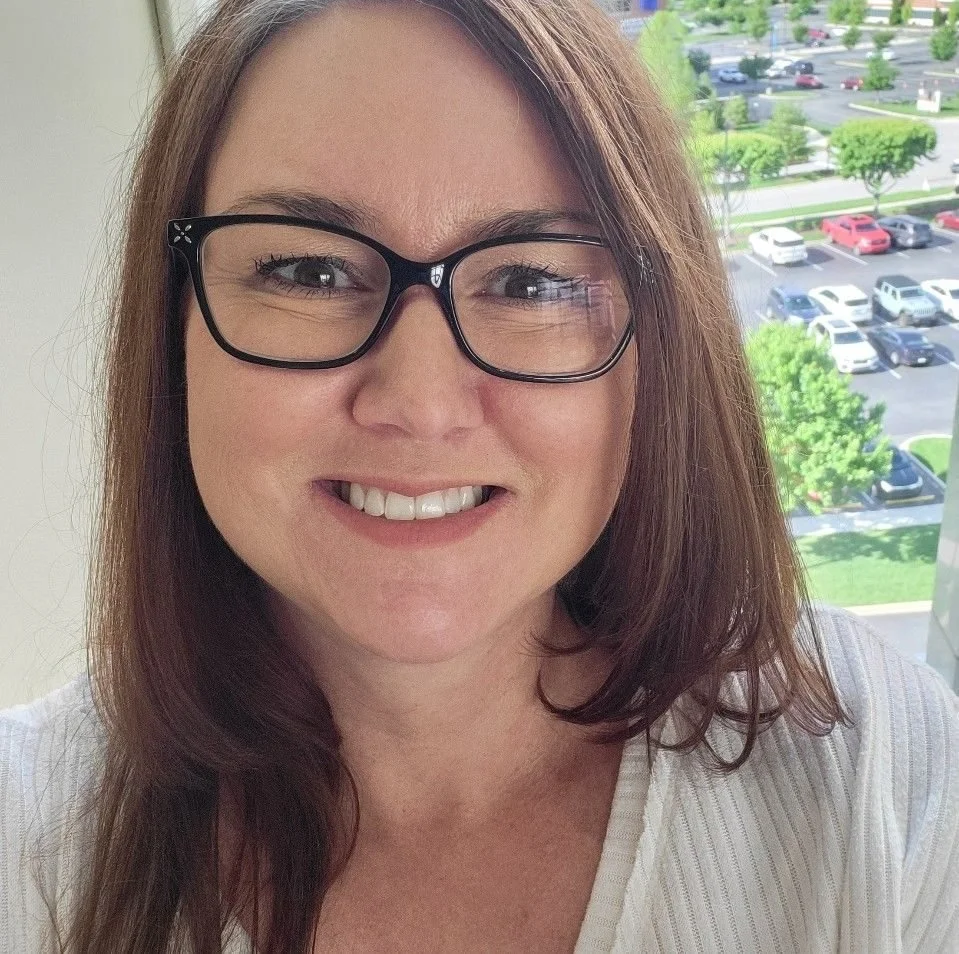 Woman with glasses and brown long hair