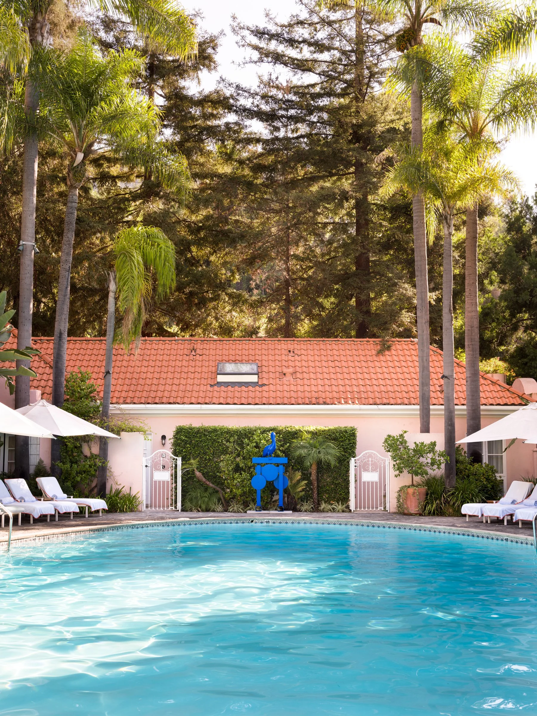 Nathan Mabry, Birdwatchers (Navigator), 2026, a blue sculpture by the pool at Hotel Bel-Air