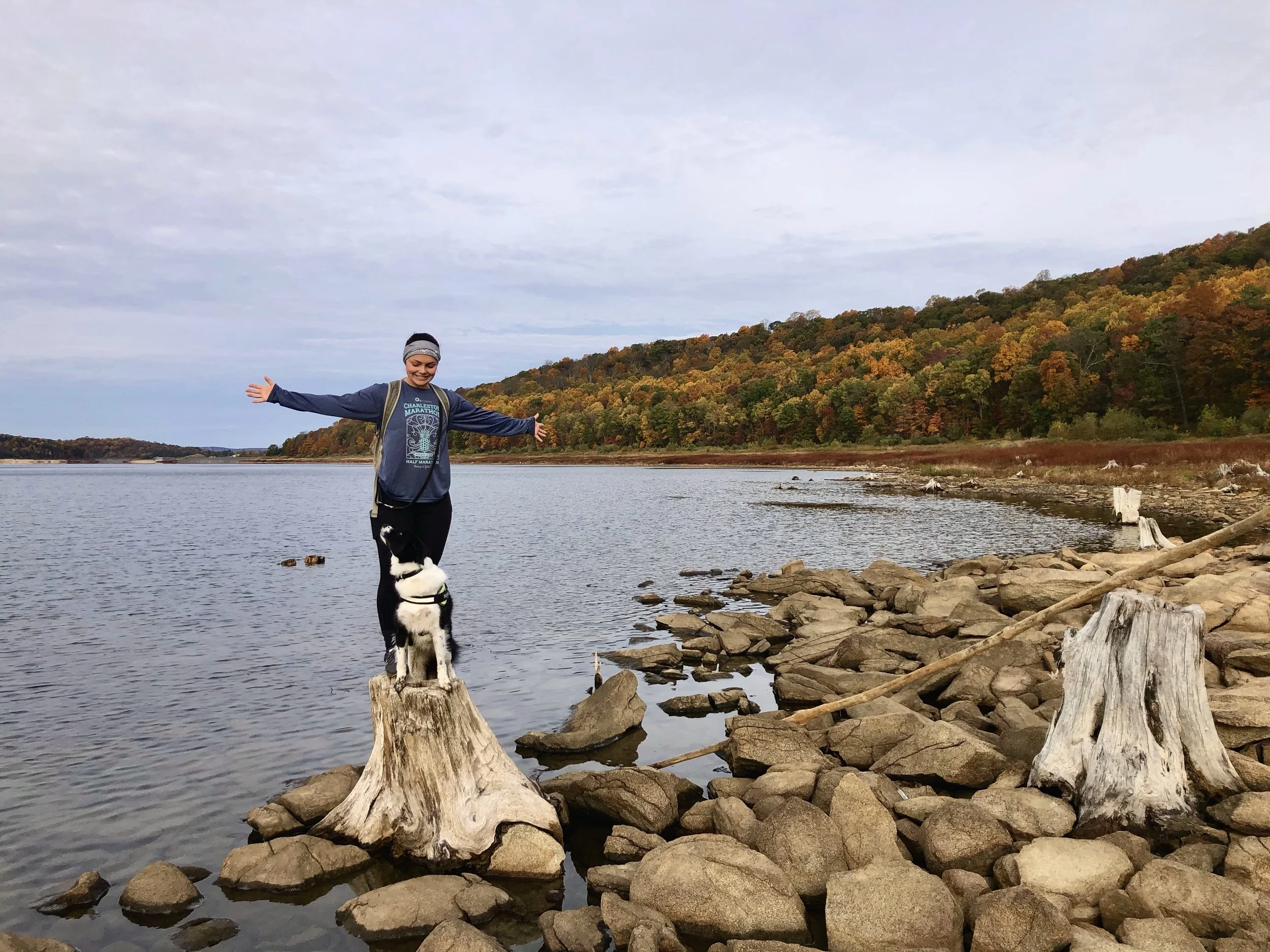 A woman and her border collie posing for a photo at Round Valley Reservoir 