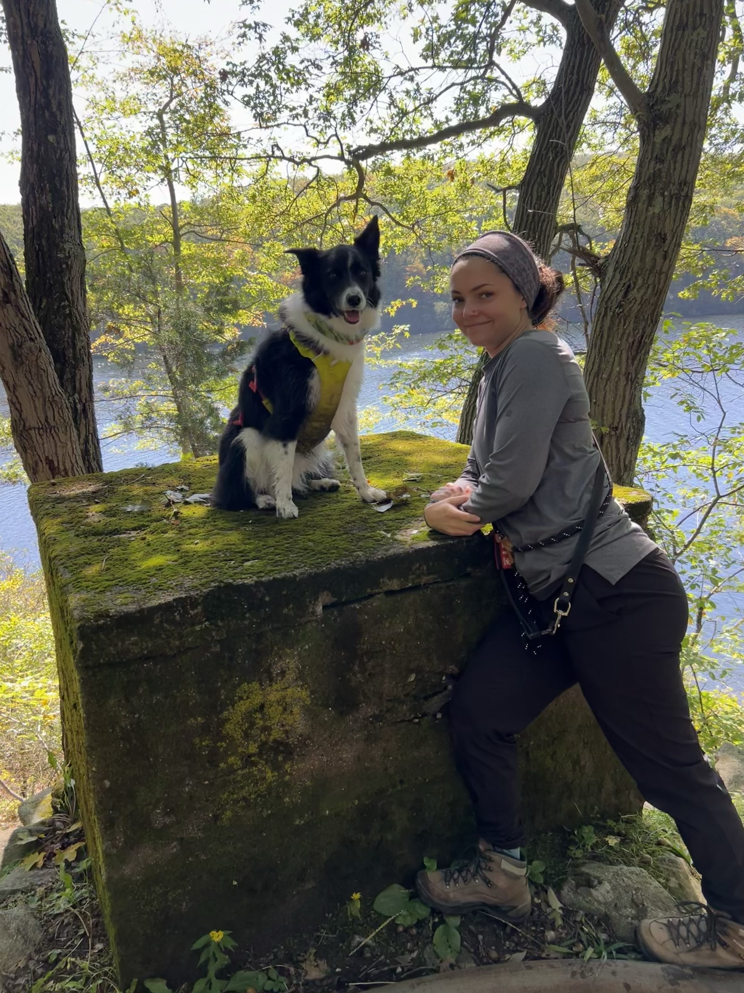 A woman and her border collie on a hike