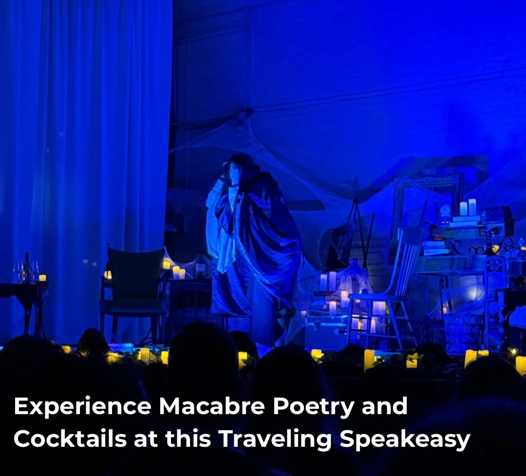 A stage decorated with candles and white drapery, with a person dressed in dark clothing performing under blue lighting, at an event called the Edgar Allen Poe Speakeasy. 