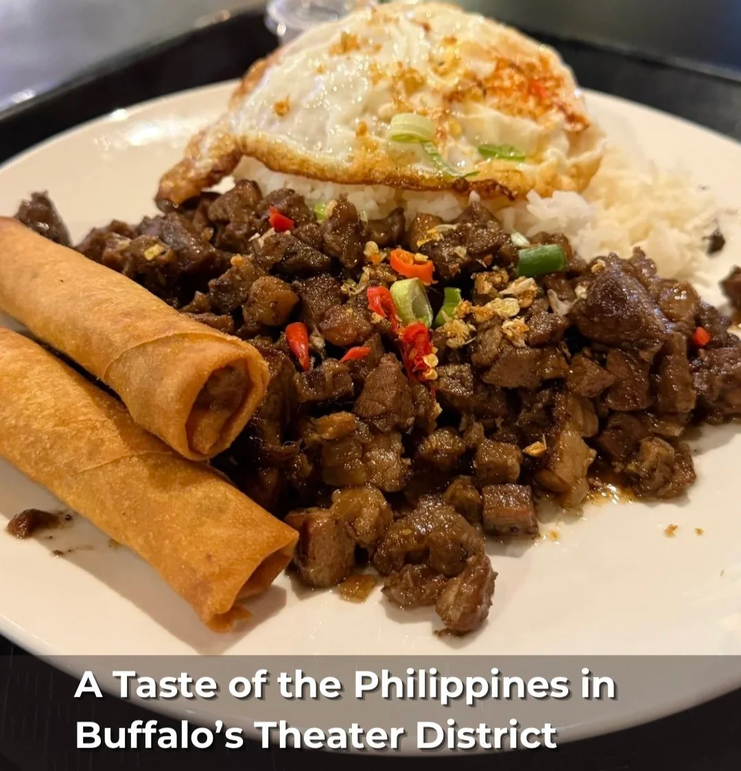 Filipino food plate with rice, fried egg, diced beef stir-fry, and spring rolls from Pinoy Boy in Buffalo, New York. 