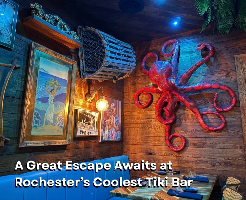 The decorated tiki bar at Easy Sailor has a large red octopus wall sculpture, vintage-style paintings, rustic wood walls, and nautical decor.