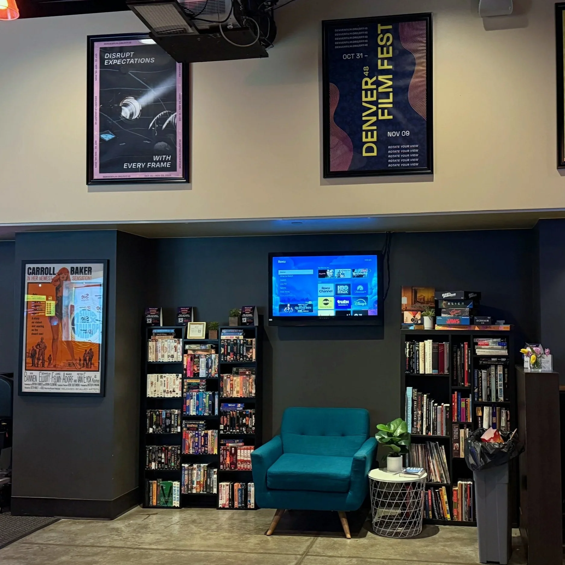 A lounging area inside the Sie Film Center with two stacked bookshelves.