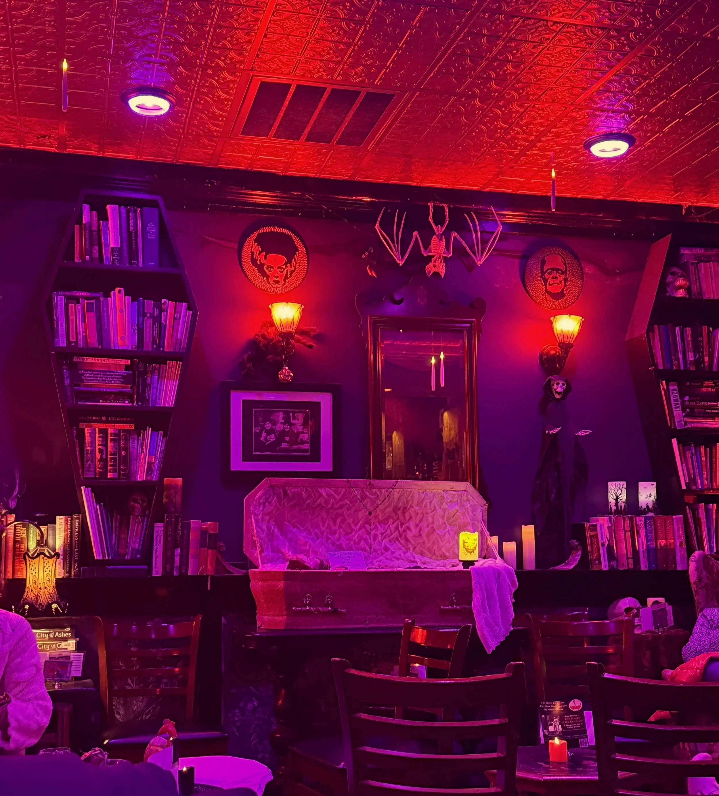 The Merry Shelley’s decorations include coffin bookshelves, a miniature coffin, and portraits of characters from the 1818 Mary Shelley novel, Frankenstein.
