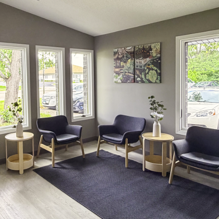Agape Health and Wellness lobby area, with chairs, end tables, flower pots, and wall art.