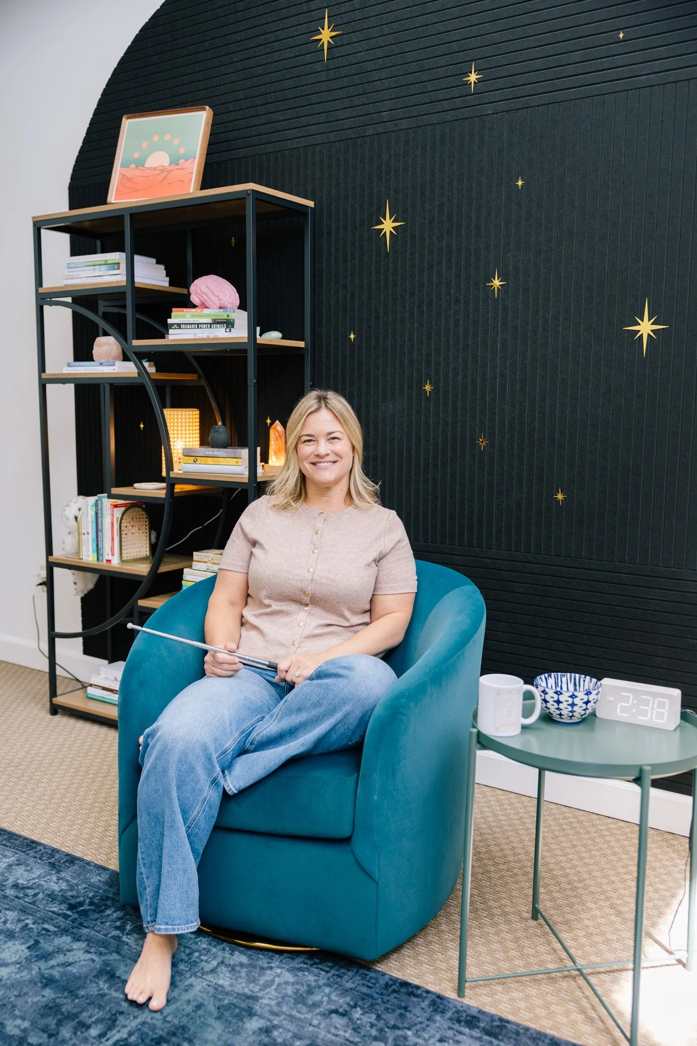 Erin Burton, LCSW in her Scotts Valley, California office holding her Brainspotting pointer.