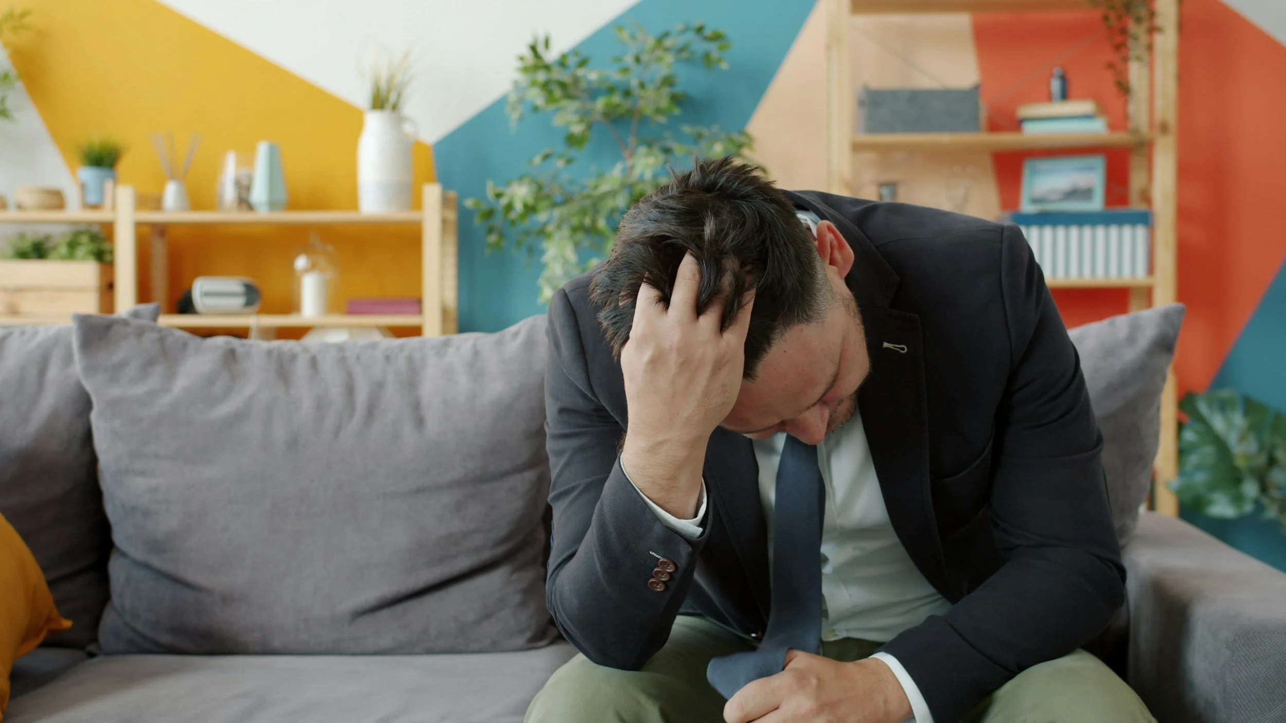 anxious and adhd adult holding his head in his hands.