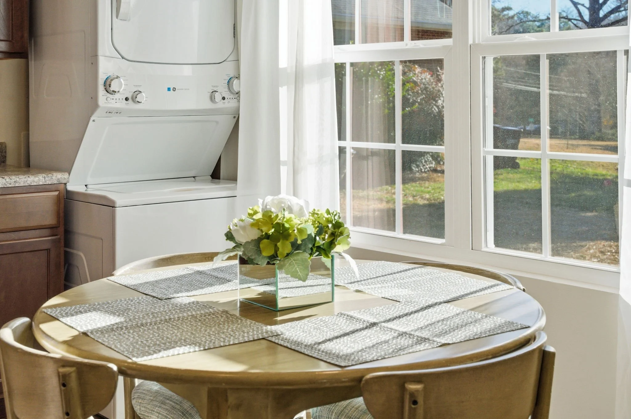 Enjoy the convenience of an in-unit washer and dryer tucked right next to the sunny dining nook. A must-have for insurance relocation and extended midterm rentals.