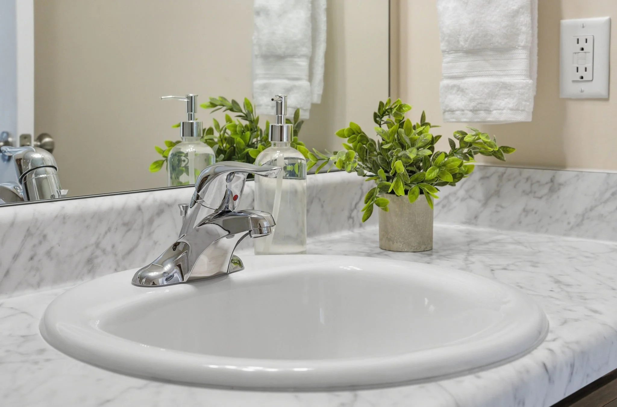 Cleanliness is our top priority. Enjoy a sparkling sink and vanity area complete with greenery and essential toiletries—perfect for getting ready before a day at Duke University or the Research Triangle Park.