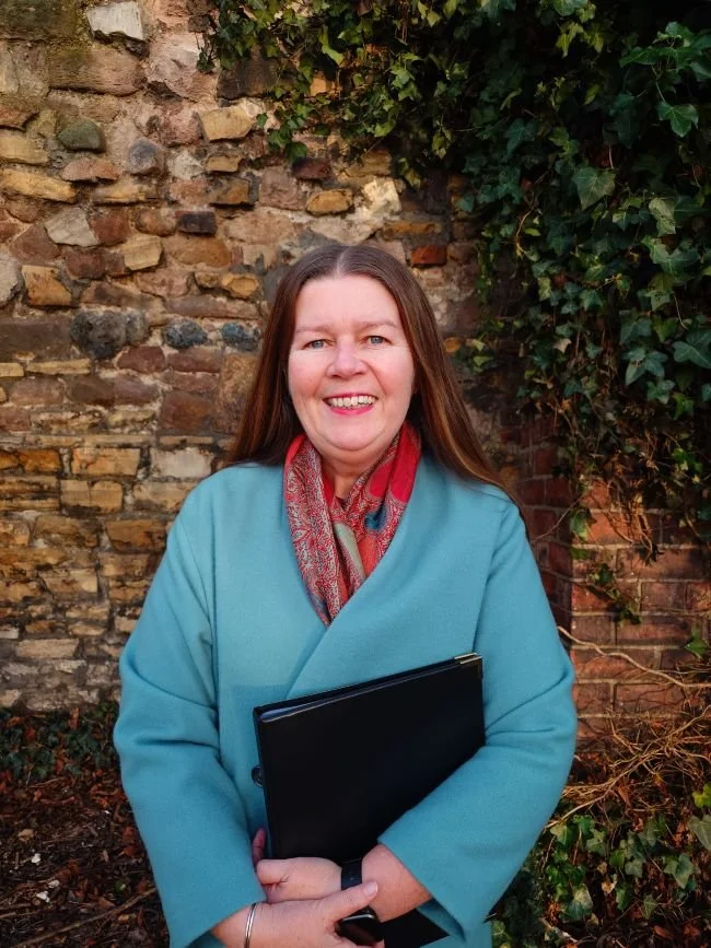 This image of Kate wearing a blue coat and brown scarf was snapped by a friend following the funeral of another friend. Kate is holding a folder containing funeral script.