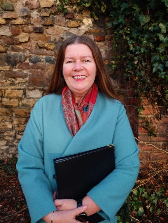 This image of Kate wearing a blue coat and brown scarf was snapped by a friend following the funeral of another friend. Kate is holding a folder containing funeral script.