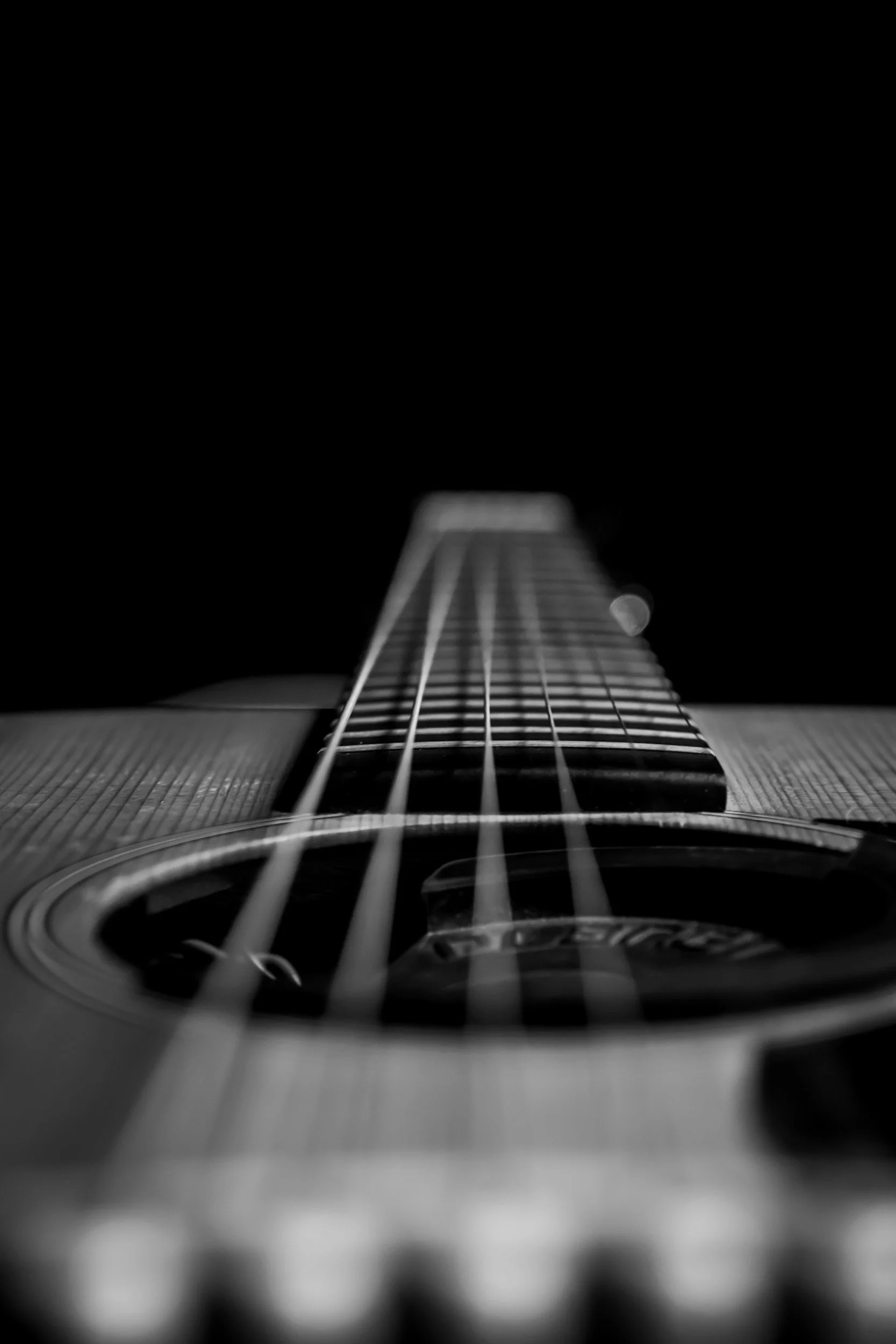 Close-up view of guitar strings and fretboard.