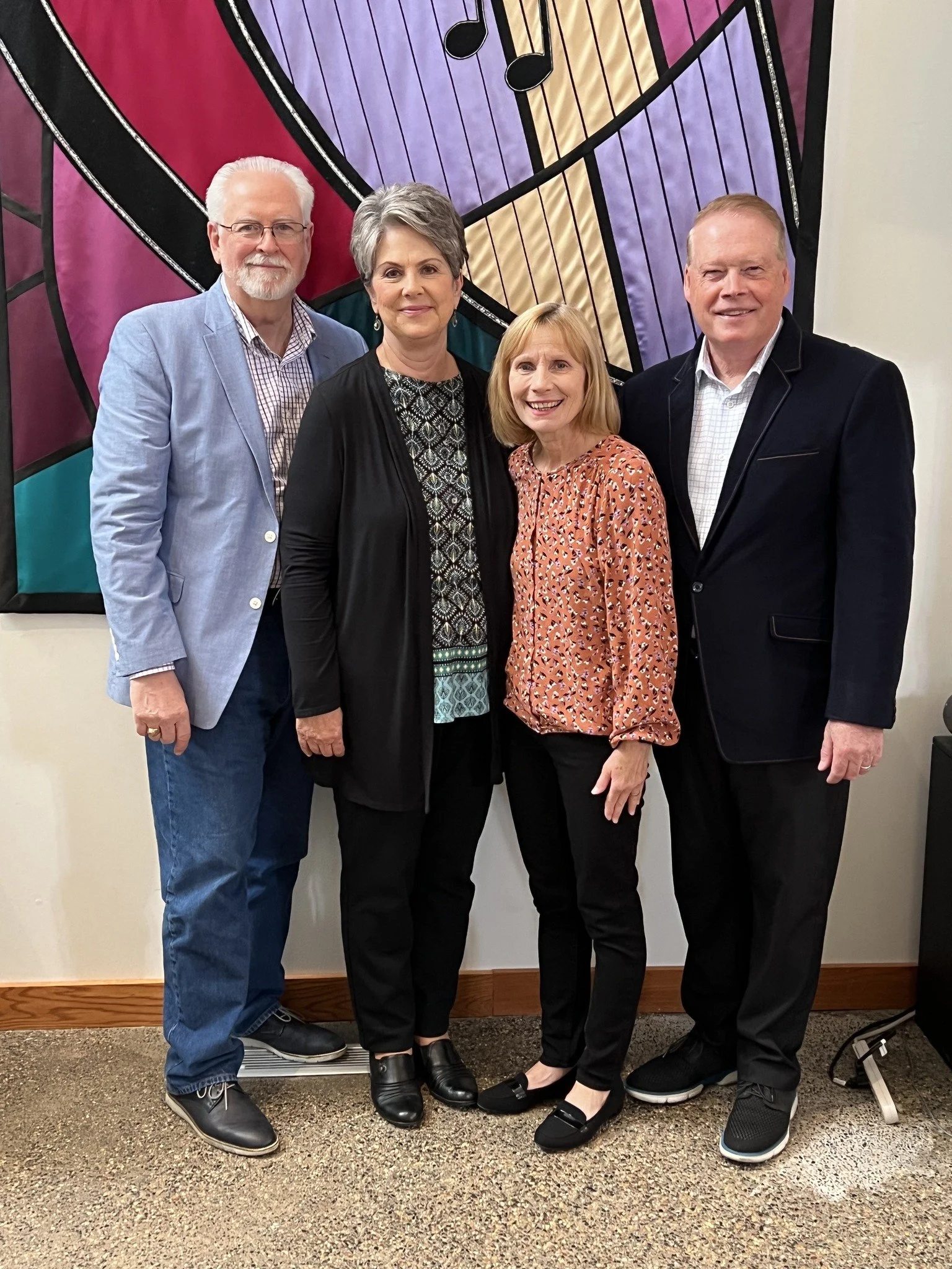 two couples smiling for a photo