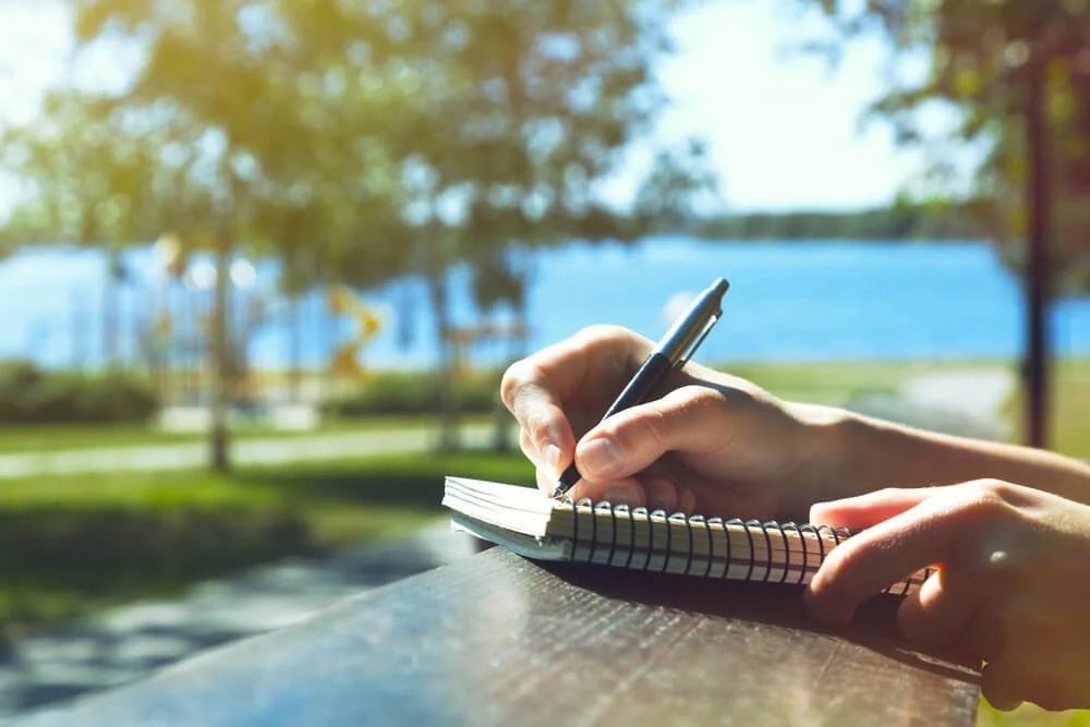 woman journaling outside