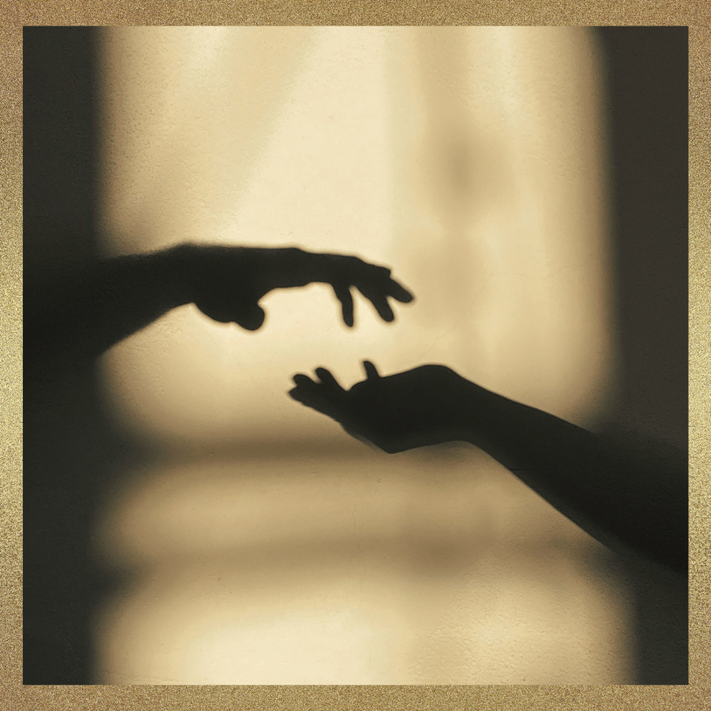 Silhouetted hands reaching toward each other, symbolizing executive presence through coherence and alignment