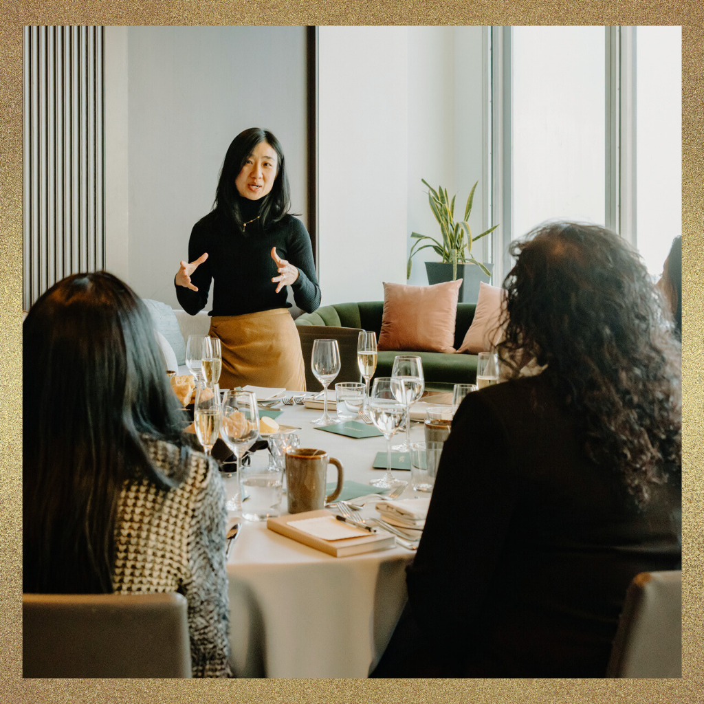 Leader speaking to a group during an executive discussion, illustrating authority and executive presence in a meeting.