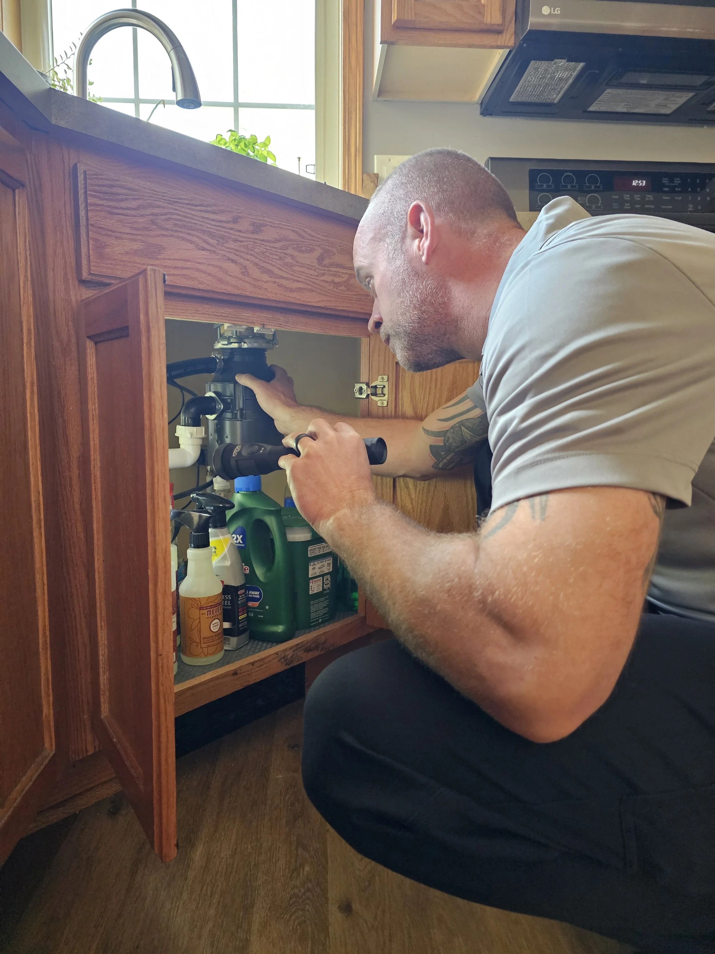 Trailblazer Home Inspections checking under the sink