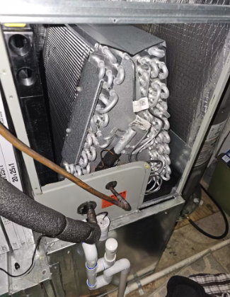 An exposed A-coil evaporator unit installed in the plenum above a residential forced-air furnace system..png
