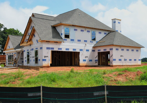 Home inspector evaluating new construction interior systems including electrical panel, plumbing fixtures, and installation quality before closing