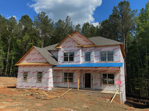 New construction home inspection showing structural framing, roofing components, and exterior systems being evaluated before closing in Minnesota