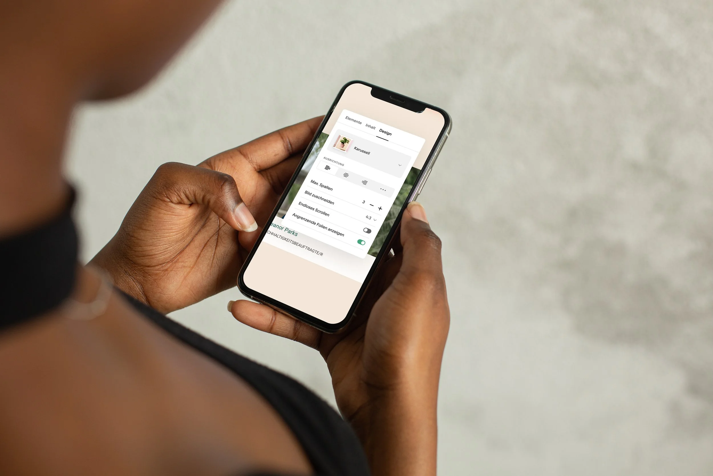 Close-up of a person with smartphone and CMS interface - stands for Noevus intuitive and easy-to-use CMS and website solutions.