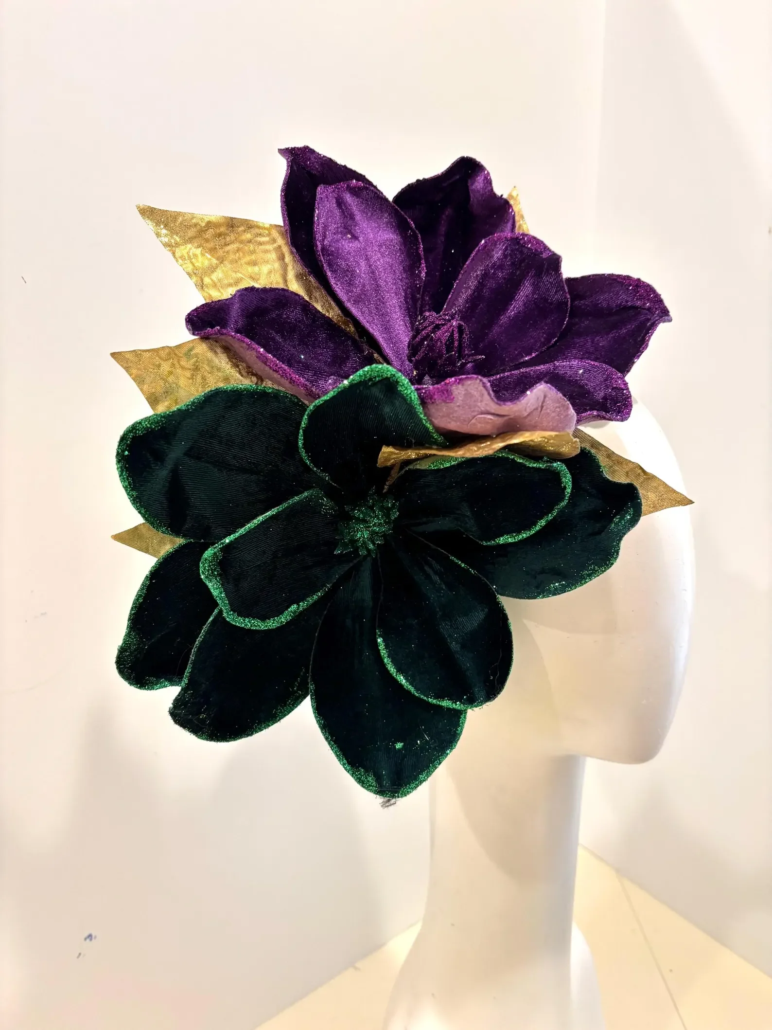 2026 Mardi Gras floral hat headwear fascinator with purple and black velvet flower, accented with gold and green leaves, handmade by Dora Marra
