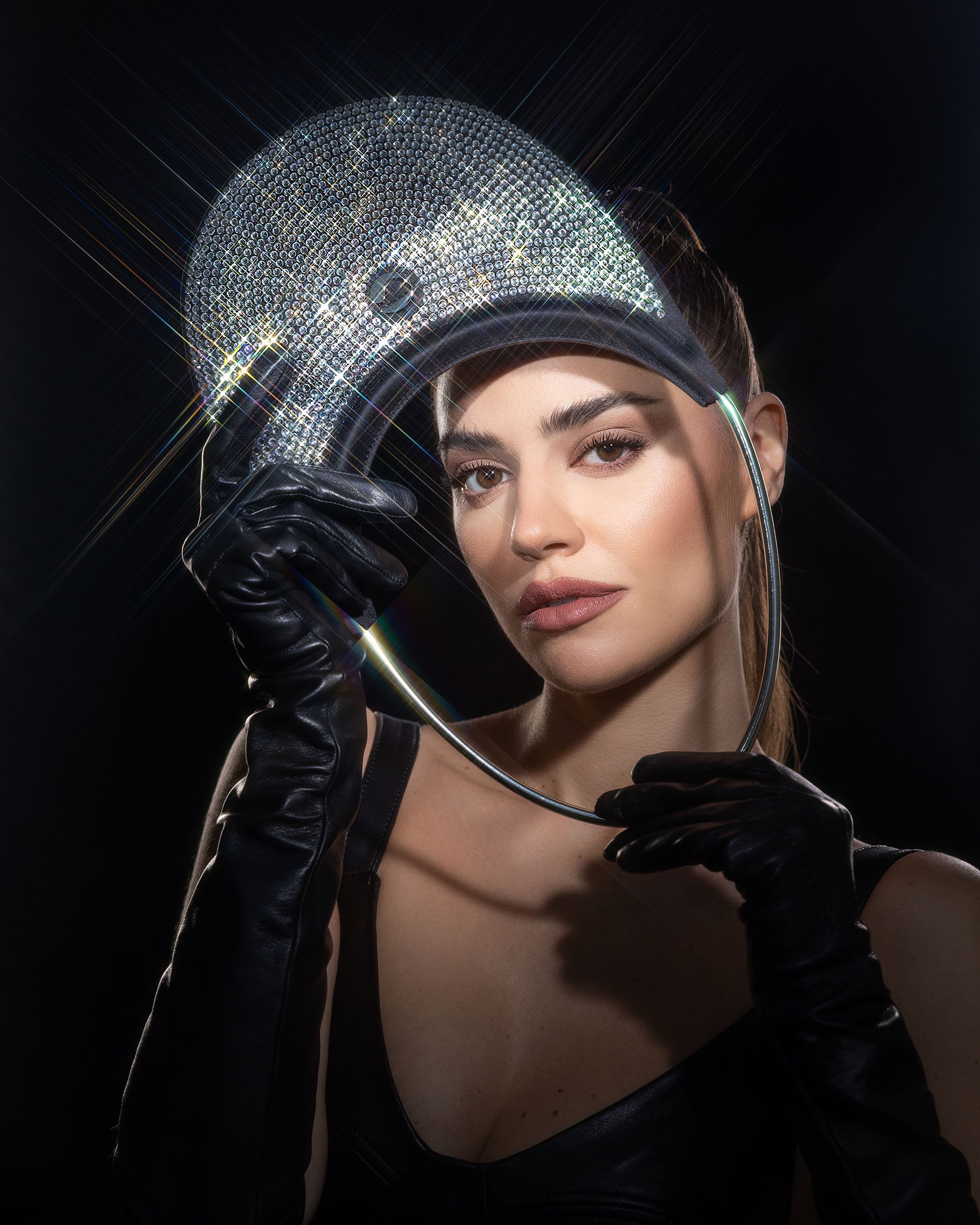 Fashion portrait with starburst filter creating light flares on reflective visor