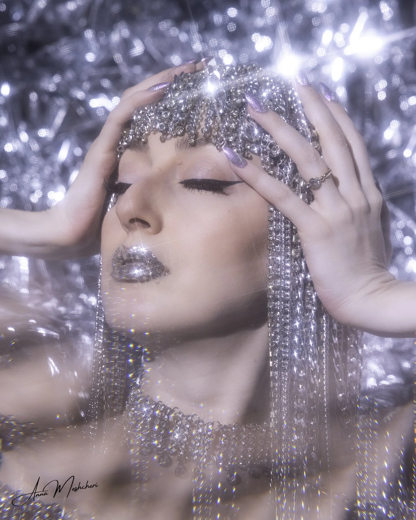 Editorial beauty portrait with star filter creating light sparkle effects on metallic accessories