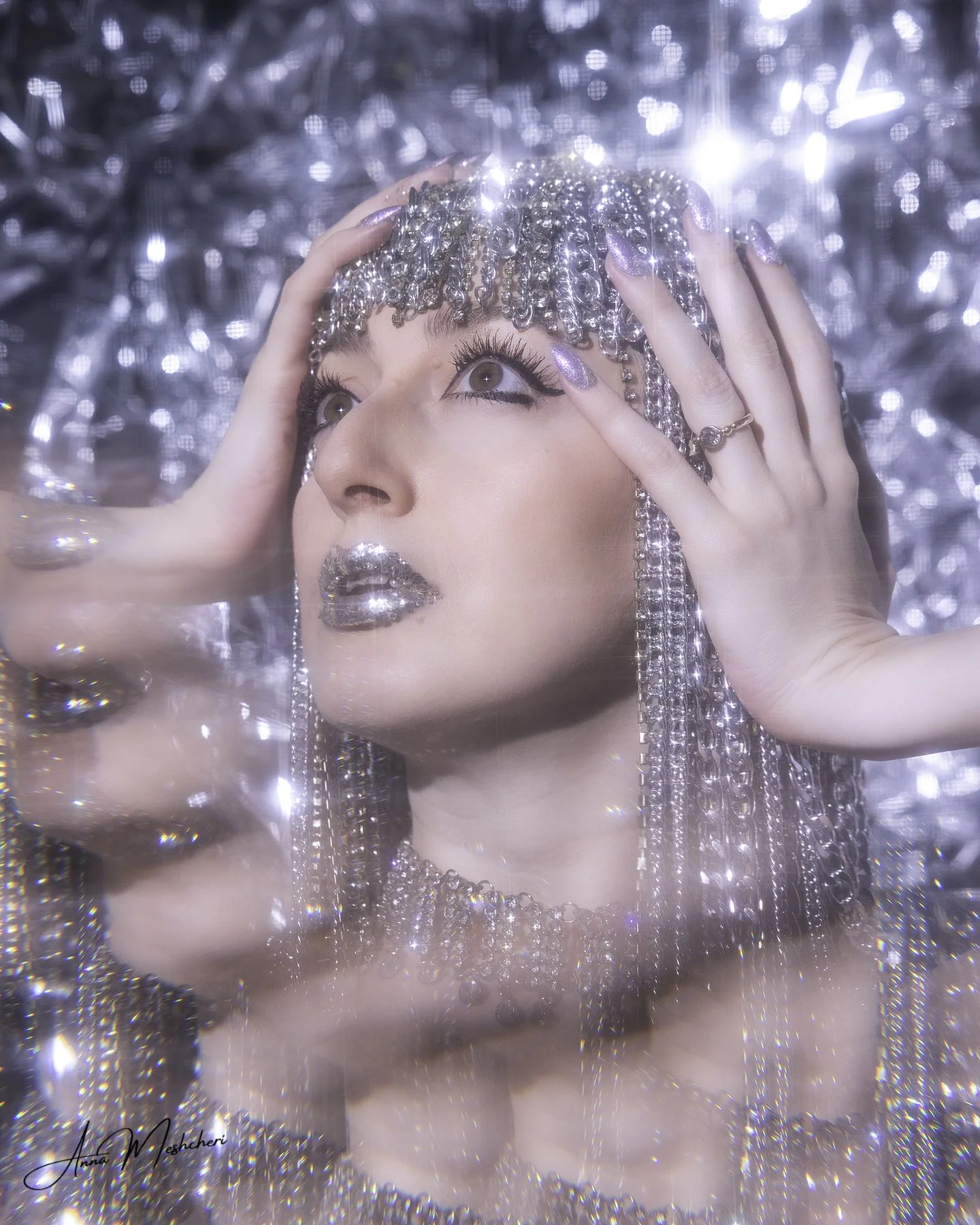 Close-up portrait with starburst filter creating sparkle effect on metallic jewelry and makeup