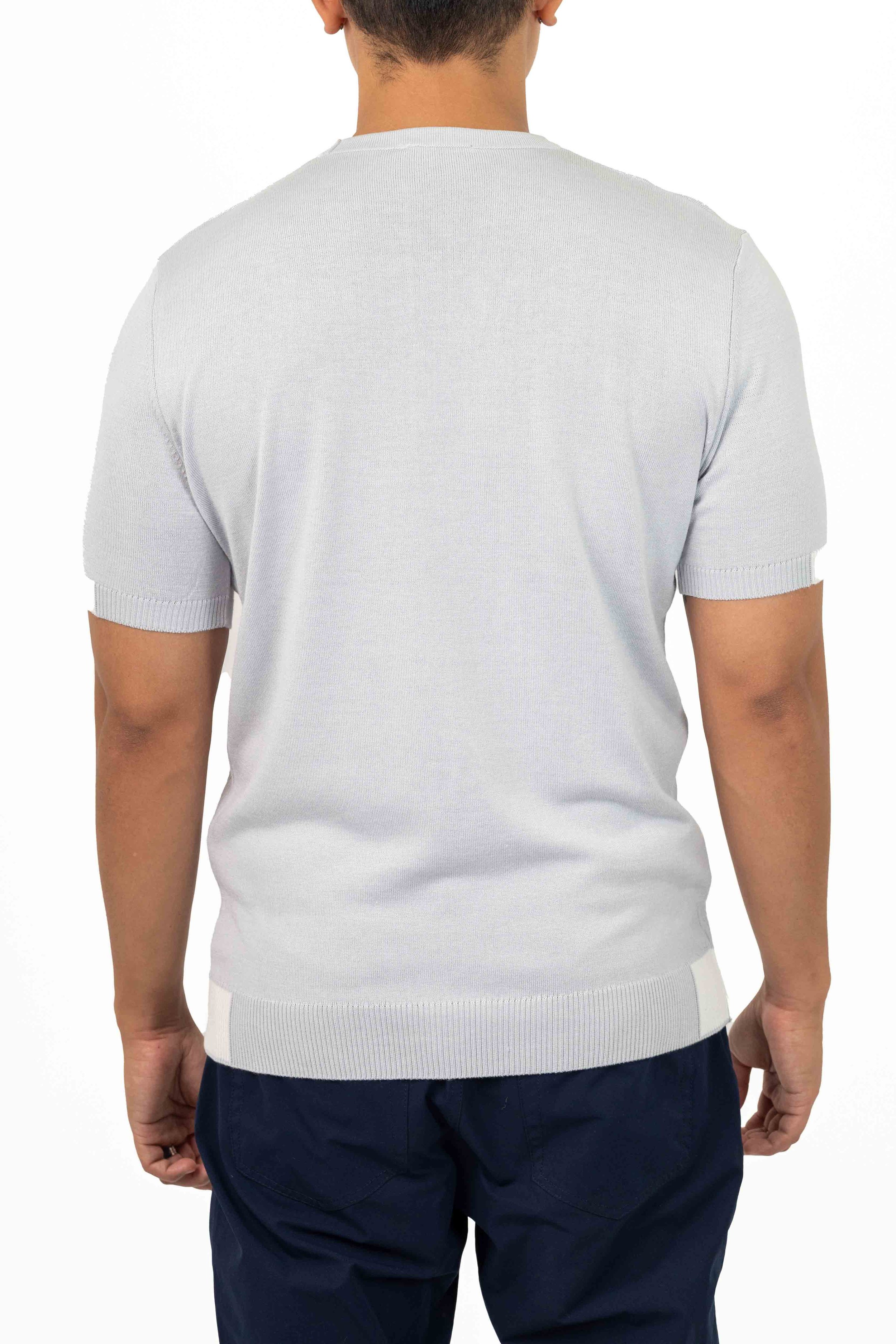 Back view of a man wearing a light gray short-sleeve sweater and navy blue pants. Catalogue Photography. Photographed by Anna Meshcheri