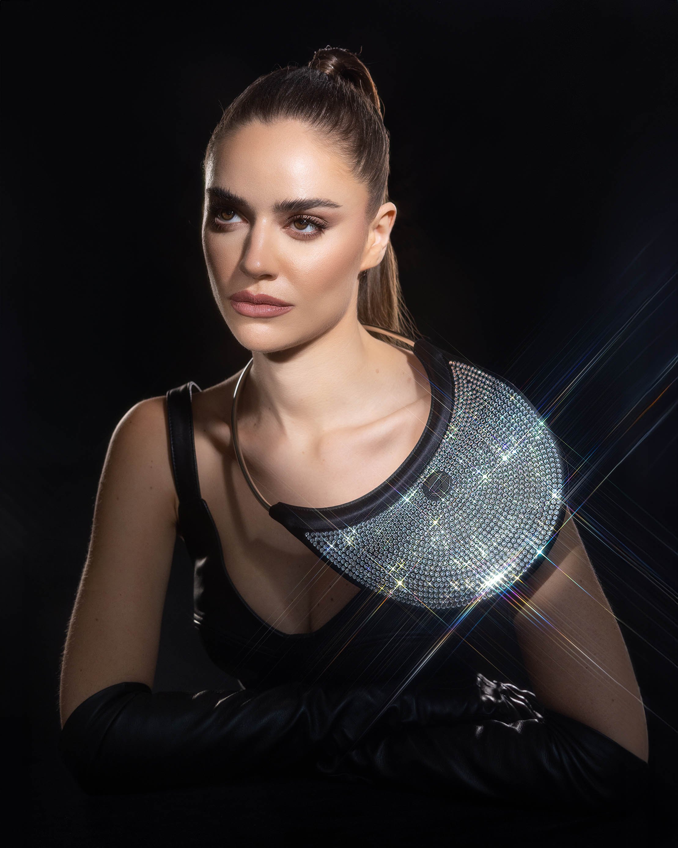 Studio fashion portrait using lens filter to create light flare effects on accessories