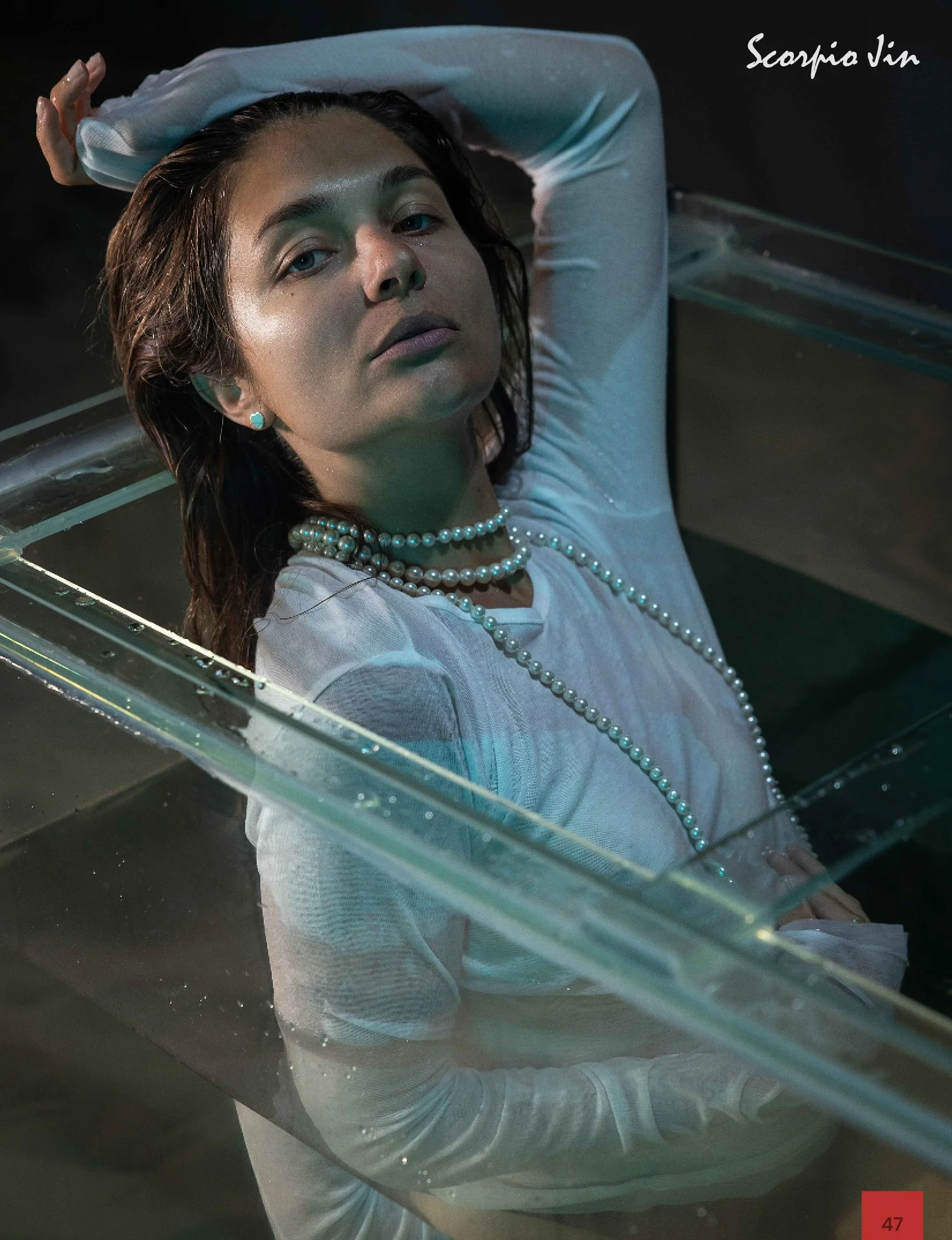 Editorial fashion photoshoot with aquarium concept, captured in a professional studio setting