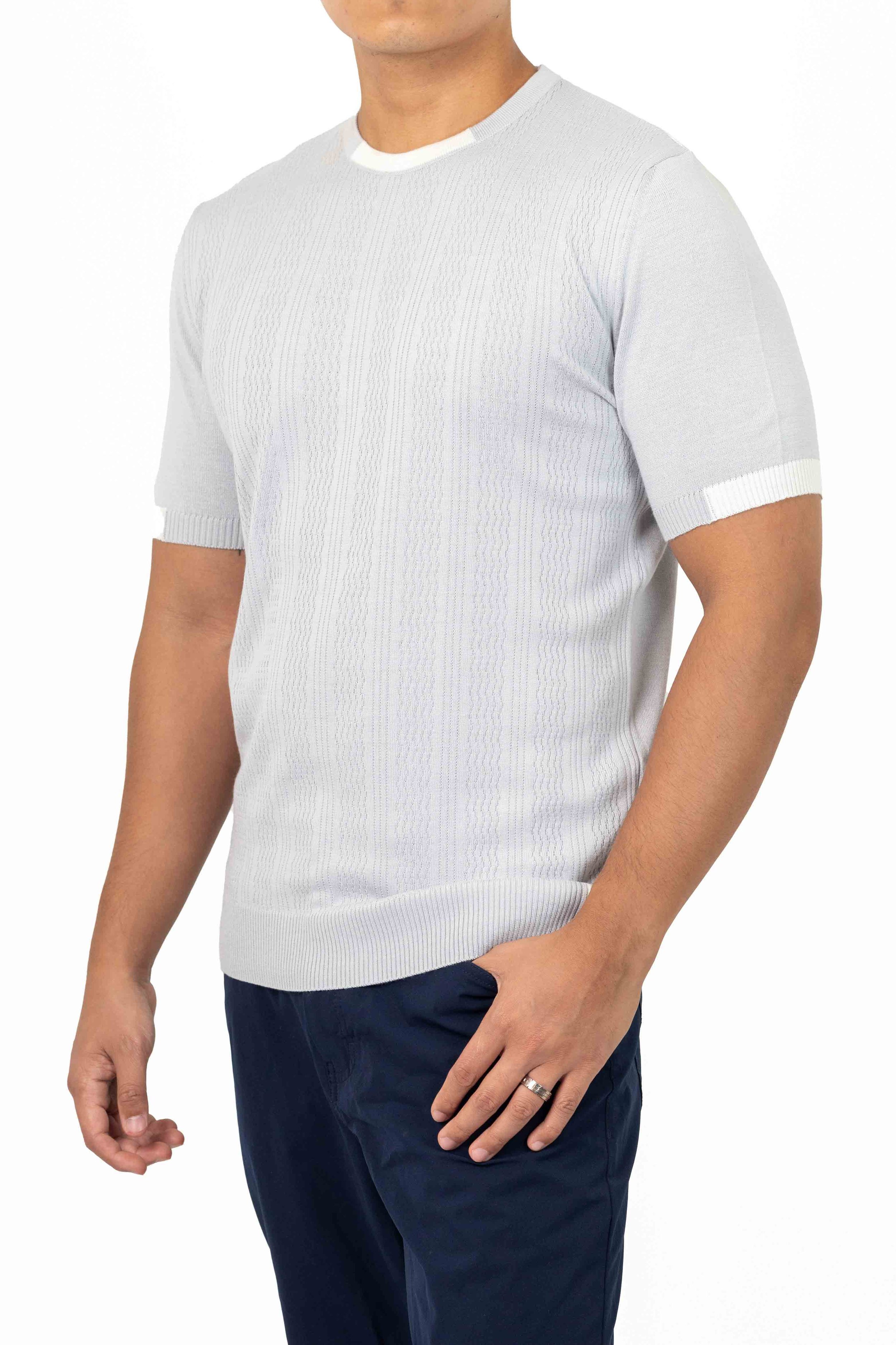 Man wearing a light gray short-sleeve sweater and dark pants with a wedding ring. Catalogue Photography. Photographed by Anna Meshcheri